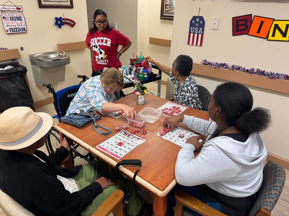 Participants playing bingo with staff at SarahCare Adult Day Care