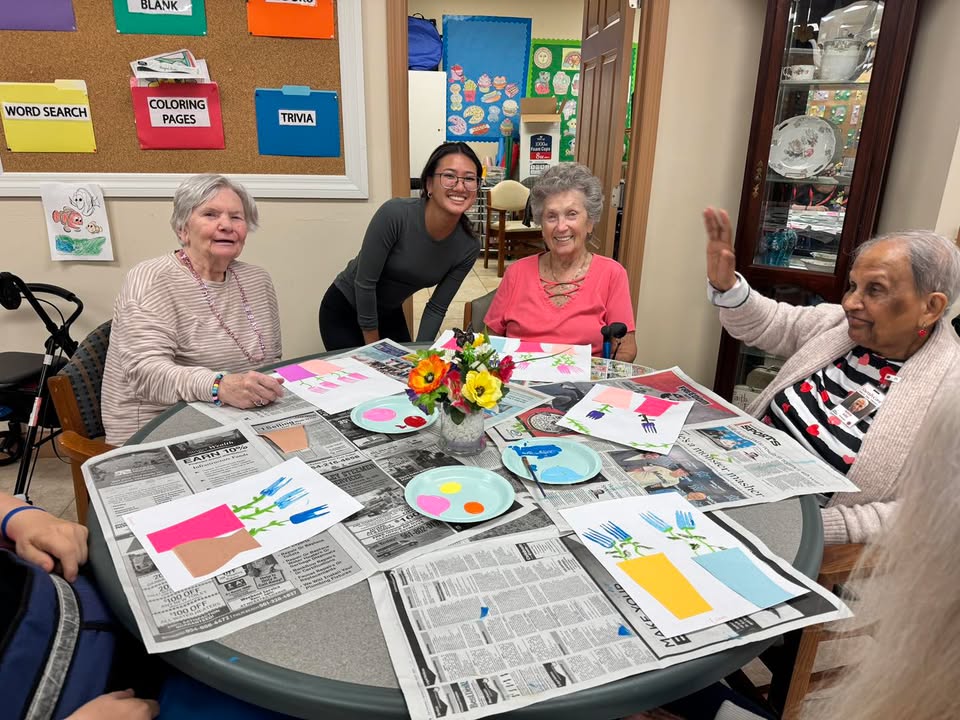 Participants smiling during a crafts activity at SarahCare Adult Day Care