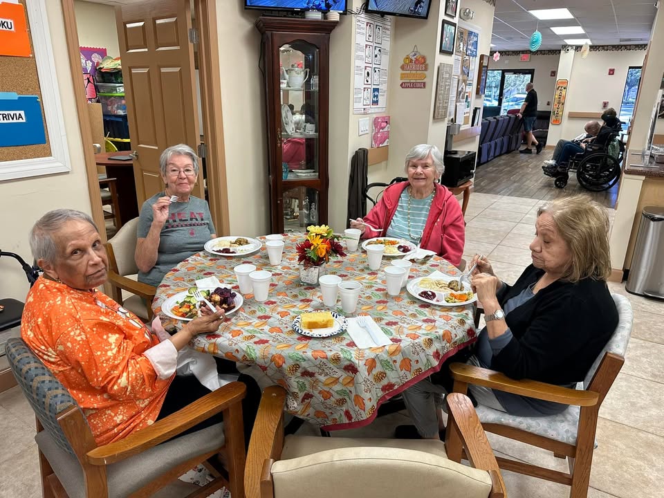 Participants enjoying lunch together at SarahCare Adult Day Care in Coral Springs