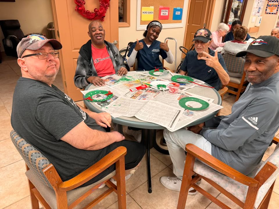 Men's group working on a craft project at SarahCare Adult Day Care