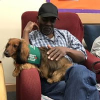 Louis with puppy at adult day care